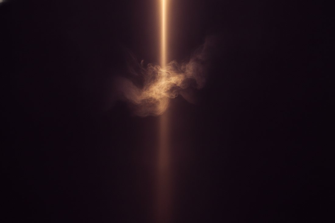 A shaft of golden light breaking through darkness